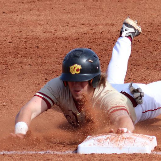 Baseball player sliding to touch a base