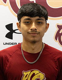 Smiling male student with black hair and moustache