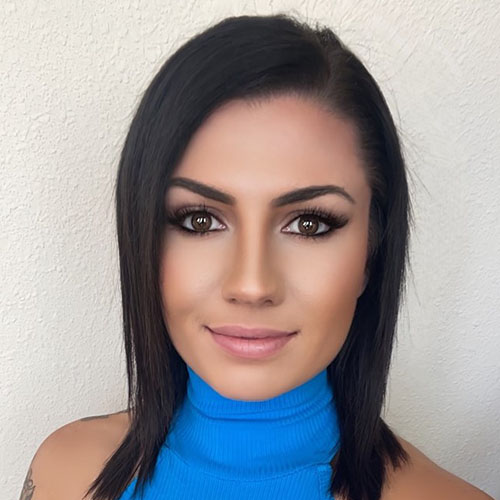 Woman with long dark hair and blue shirt