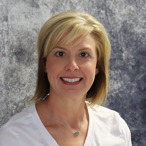 Woman with blonde hair wearing a white shirt