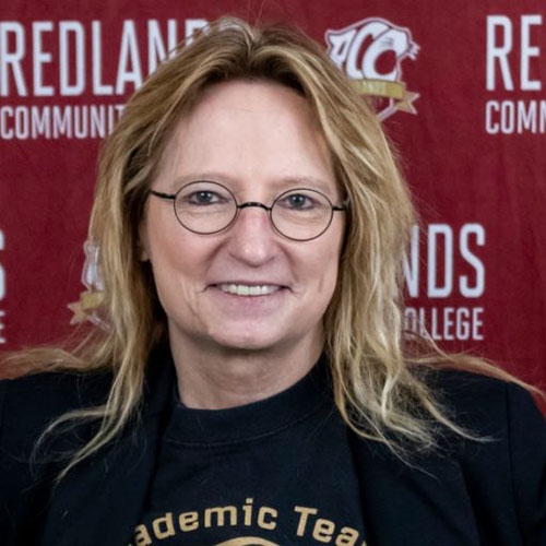 Woman with long brown hair and glasses