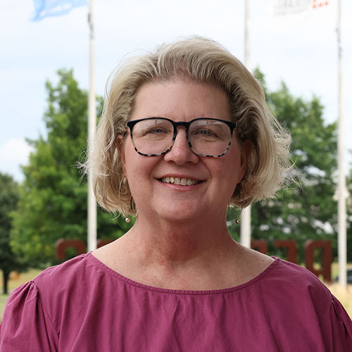 Woman with blonde hair and glasses