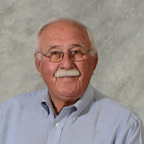 Man with gray hair and moustache wearing glasses