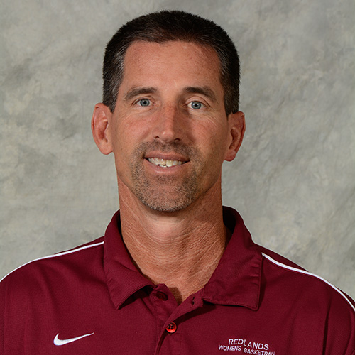 Man with short dark hair wearing a red shirt