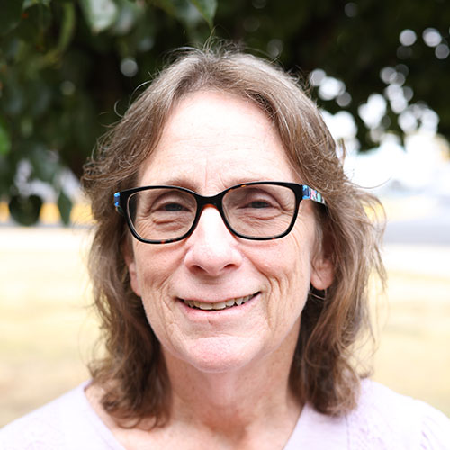 Woman with brown hair and glasses