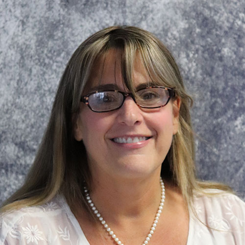 Woman with long brown hair and glasses