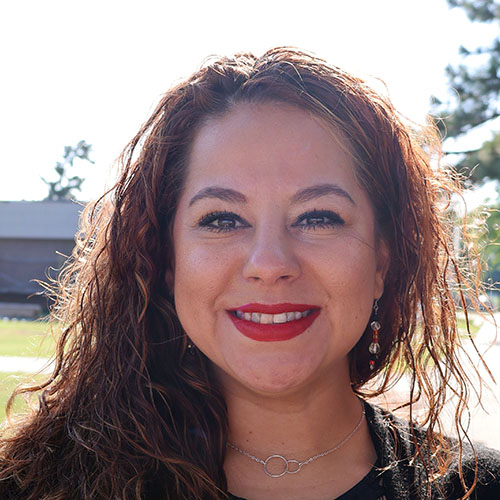 Woman with long dark curly hair