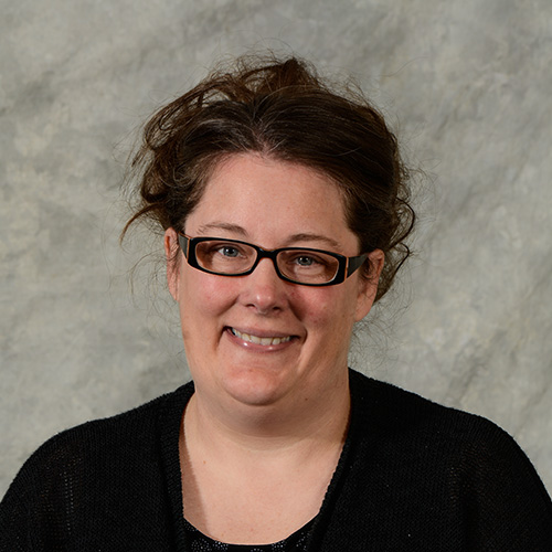 Woman with dark hair and glasses