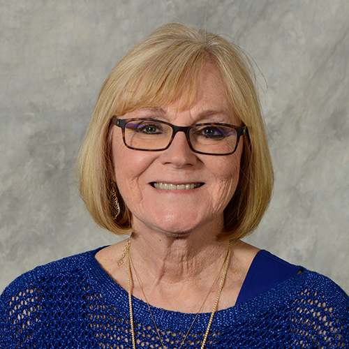 Woman with blonde hair and glasses