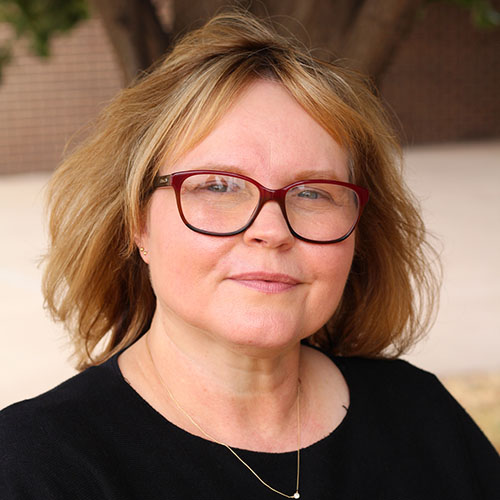 Woman with blonde hair and glasses