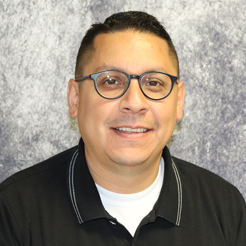 Man with short dark hair and glasses