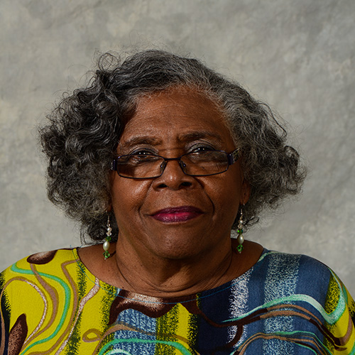 Woman with dark gray hair and glasses