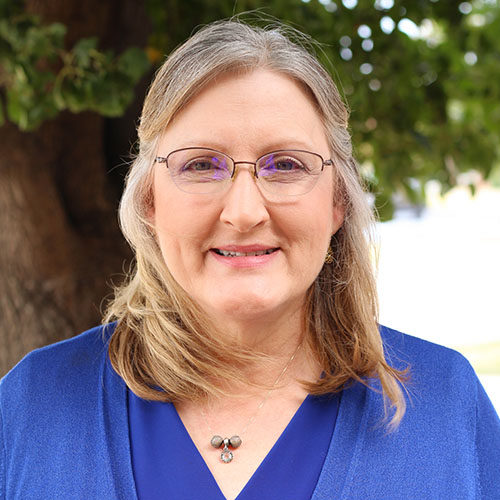 woman with long blonde hair and glasses