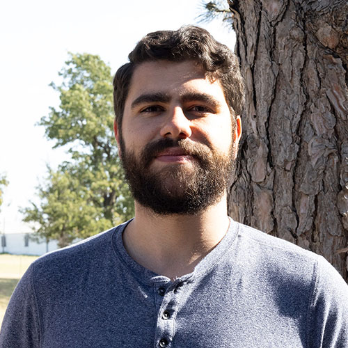 Man with dark hair and beard